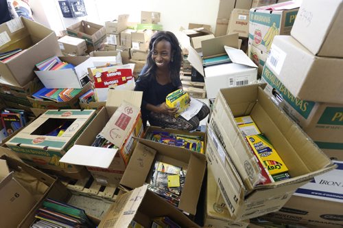 The cast and members of the production of the Manitoba Theatre for Young People's play "Danny, King of the Basement" lent a hand sorting supplies for the Winnipeg Harvest's Tools for School program Thursday. Actor Bev Ndukwu helps fill an order for students needing school supplies in Winnipeg. "Danny, King of the Basement" is a play about poverty and finding creative solutions to difficult situation. Wayne Glowacki / Winnipeg Free Press September 17 2015