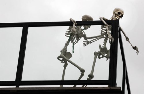 Two skeletons hanging out on a second floor sun deck on Masson St in St Boniface in Winnipeg- Standup Photo- Sept 17, 2015   (JOE BRYKSA / WINNIPEG FREE PRESS)