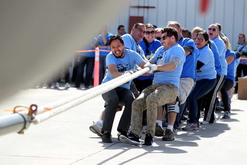 Employees with Pollard Banknote give it their all as they try to be the fasted in pulling a Hercules aircraft over a finish line in the 12th annual Plane Pull with proceeds from the  event  going to the United Way.   Standup photo  Sept 18, 2015  Ruth Bonneville / Winnipeg Free Press