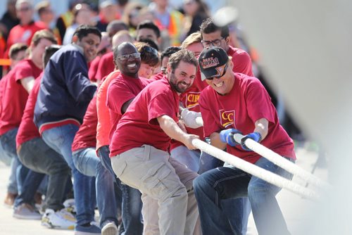 Employees with CIBC give it their all as they try to be the fasted in pulling a Hercules aircraft over a finish line in the 12th annual Plane Pull with proceeds from the  event  going to the United Way.   Standup photo  Sept 18, 2015  Ruth Bonneville / Winnipeg Free Press