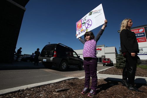 Seven-year-old Victoria Russell a friend of the Krull family, holds a sign advertising Whistles and safety whistles and bracelets to raise reward money for information on the whereabouts of Thelma Krull at Tim Hortons on Plessis Ave. Saturday.   51-year-old Thelma Krull went missing over 2 months ago in the Transcona area.    Standup photo Sept 19, 2015   Ruth Bonneville /Winnipeg Free Press