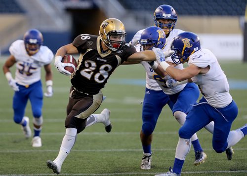 University of Manitoba Bisons' Jamel Lyles is forced out of bounds by a few University of British Columbia Thunderbirds' defenders during the first half of their game, Saturday, September 19, 2015. (TREVOR HAGAN/WINNIPEG FREE PRESS)