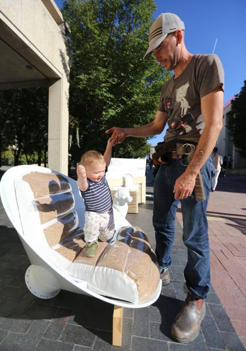 Dave Pancoe, and his son, Henry, 1, check out Chair Your Ideas on King Street in front of City Hall, Saturday, September 19, 2015. (TREVOR HAGAN/WINNIPEG FREE PRESS)