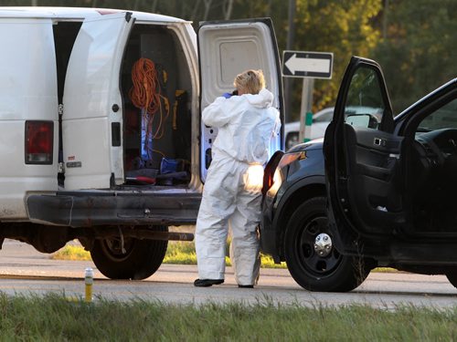 RCMP forensics officer gathers evidence at the scene of a police shooting on Hyw 59 at Kirkness Road Monday morning-Appears to be handgun on hyw Breaking News- See Carol Sanders story- Sept 21, 2015   (JOE BRYKSA / WINNIPEG FREE PRESS)