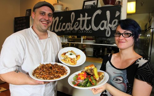 ENT - REVIEW - Nicolett Cafe (632 rue LaFleche). Chef Leighton Fontaine and staff Sara Wonnacott pose for a photo in the new restaurant. (L-R)  Manitoba poutine, potato cheddar perogies, and beef brisket. BORIS MINKEVICH / WINNIPEG FREE PRESS PHOTO Sept. 21, 2015
