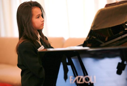 Ten yr old Sarah plays her new Fazioli piano. Most people have never heard of piano brand Fazioli before, but for a pianist  its like hearing the name Ferrari, or Lamborghini. They are regarded today as being the finest pianos ever made  and this is the first one ever to come to Winnipeg. Chick Corea and Herbie Hancock have both signed the harp inside the instrument. (so I gues it's "used". Holly Harris story.  SEPTEMBER 21, 2015 - (PHIL HOSSACK / WINNIPEG FREE PRESS)