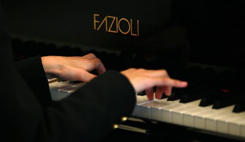 Ten yr old Sarah plays her new Fazoli piano. Most people have never heard of piano brand Fazioli before, but for a pianist  its like hearing the name Ferrari, or Lamborghini. They are regarded today as being the finest pianos ever made  and this is the first one ever to come to Winnipeg. Chick Corea and Herbie Hancock have both signed the harp inside the instrument. (so I gues it's "used". Holly Harris story.  SEPTEMBER 21, 2015 - (PHIL HOSSACK / WINNIPEG FREE PRESS)