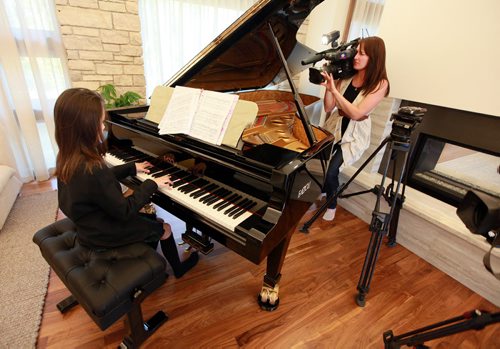 Ten yr old Sarah plays her new Fazoli piano. Most people have never heard of piano brand Fazioli before, but for a pianist  its like hearing the name Ferrari, or Lamborghini. They are regarded today as being the finest pianos ever made  and this is the first one ever to come to Winnipeg. Chick Corea and Herbie Hancock have both signed the harp inside the instrument. (so I gues it's "used". Holly Harris story.  SEPTEMBER 21, 2015 - (PHIL HOSSACK / WINNIPEG FREE PRESS)