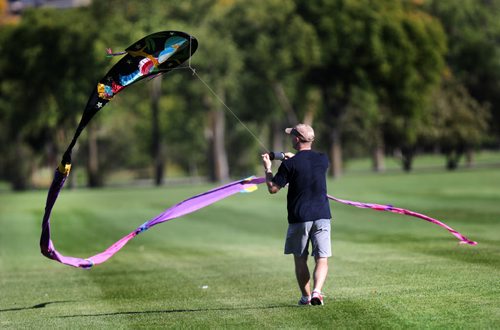 Dan Van Nice comes to terms with his kite Monday afternoon at Assinaboine Park. Dan and his family were taking advantage of fall winds and warm sun to launch their kites one last time! STAND-UP. SEPTEMBER 21, 2015 - (PHIL HOSSACK / WINNIPEG FREE PRESS)