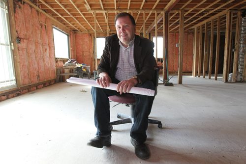 City Church Pastor, Tim Nielsen, holds drawings for Naomi House,  a transitional housing for newly-arrived refugees and refugee claimants of any faith being built in former appliance repair shop on Ellice Ave. See Carol Sanders story.  Sept 22, 2015   Ruth Bonneville /Winnipeg Free Press