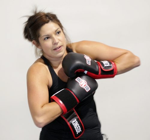 Kelly Porath squeezes into new gloves for the squared ring Wednesday evening prepping for a charity bout. See Melissa Martin's story. September 23, 2015 - (PHIL HOSSACK / WINNIPEG FREE PRESS)