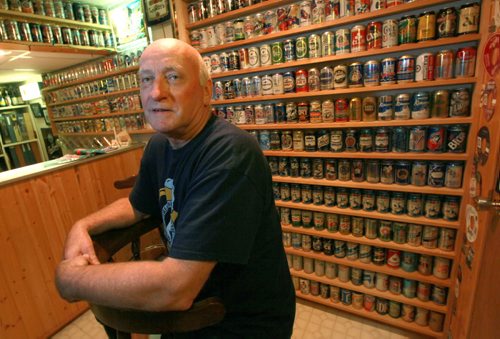 Rob Horwood is the founder of the Great White North Brewerianists club - the group is hosting its annual show & sale on Oct 3 - we're talking beer cans - Rob has one wall in his basement lined with 100s of cans (all empty, sorry) - even better, the  beer can turns 80 years young this year! So shots of Rob showing off his collection - besides specializing in Canadian cans, he also has an impressive display of Harley-Davidson cans - and binder upon binder of rare beer labels, too... See Dave Sanderson story. September 23, 2015 - (PHIL HOSSACK / WINNIPEG FREE PRESS)