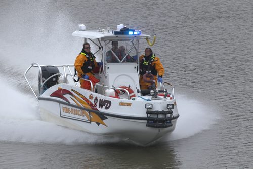 Fire Dept water rescue boat approaches a body that was spotted in the water east of the Louise bridge Friday morning - See Carol Sanders story- Sept 25, 2015   (JOE BRYKSA / WINNIPEG FREE PRESS)