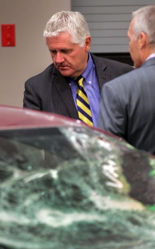 Minister Gord MacIntosh looks ove a vehicle written off due to vandalism prior to at an MPI announcement today eliminating deductable in some cases for vandalism. See Geoff Kirbyson's story. September 25, 2015 - (PHIL HOSSACK / WINNIPEG FREE PRESS)