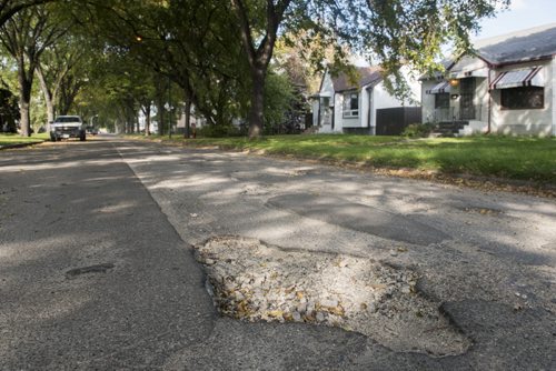 DAVID LIPNOWSKI / WINNIPEG FREE PRESS 150925 September 25, 2015  Potholes on Ashburn Street between Ellice Avenue and Sargent Avenue seen Friday September 25, 2015.