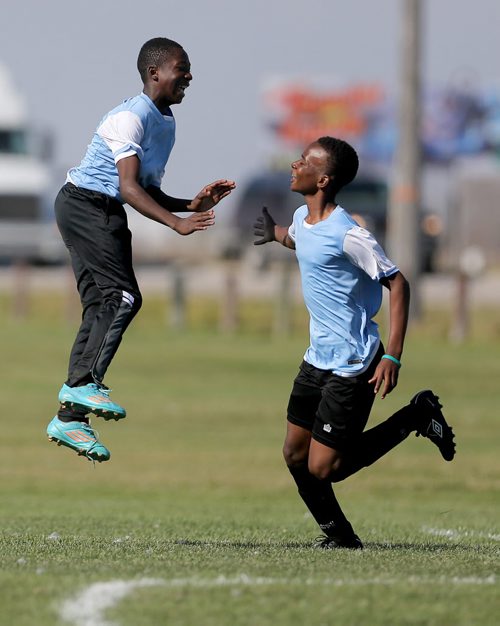 Two players from IRCOM, The Immigrant and Refugee Community Organization of Manitoba Inc. soccer team, celebrate a goal during their game against St. Johns Ravenscourt during the final game of the boys under 13 city recreation final at John Blumberg, Saturday, September 26, 2015. (TREVOR HAGAN/WINNIPEG FREE PRESS)