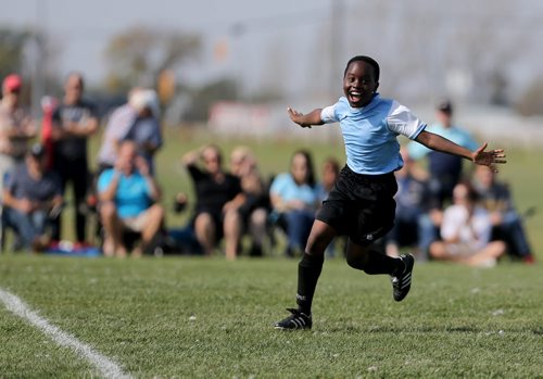 Frank Nayituriki from IRCOM, The Immigrant and Refugee Community Organization of Manitoba Inc. soccer team, celebrates after defeating St. Johns Ravenscourt during the final game of the boys under 13 city recreation final at John Blumberg, Saturday, September 26, 2015. (TREVOR HAGAN/WINNIPEG FREE PRESS)