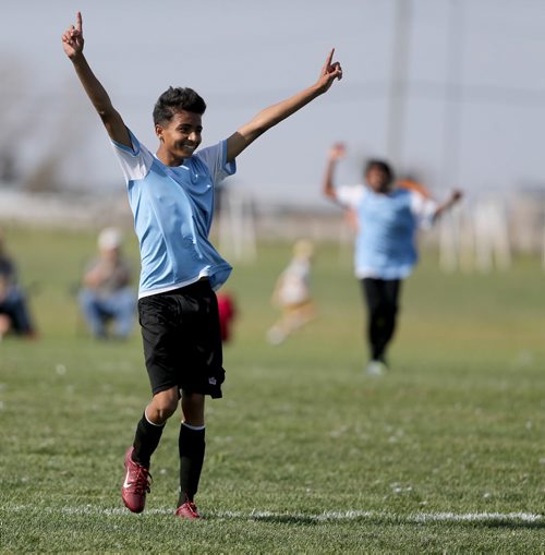 Pawan Giri from IRCOM, The Immigrant and Refugee Community Organization of Manitoba Inc. soccer team, celebrates after defeating St. Johns Ravenscourt during the final game of the boys under 13 city recreation final at John Blumberg, Saturday, September 26, 2015. (TREVOR HAGAN/WINNIPEG FREE PRESS)