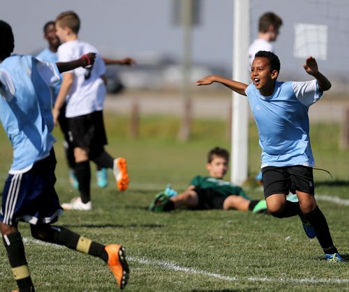A player from IRCOM, The Immigrant and Refugee Community Organization of Manitoba Inc. soccer team, celebrates after scoring goal during their game against St. Johns Ravenscourt during the final game of the boys under 13 city recreation final at John Blumberg, Saturday, September 26, 2015. (TREVOR HAGAN/WINNIPEG FREE PRESS)