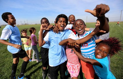 The players from IRCOM, The Immigrant and Refugee Community Organization of Manitoba Inc. soccer team, celebrate with friends and family after defeating St. Johns Ravenscourt in the final of the boys under 13 city recreation final at John Blumberg, Saturday, September 26, 2015. (TREVOR HAGAN/WINNIPEG FREE PRESS)