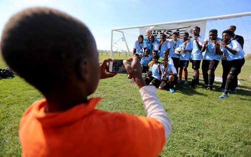 The players from IRCOM, The Immigrant and Refugee Community Organization of Manitoba Inc. soccer team, pose with their trophy after defeating St. Johns Ravenscourt, following the final game of the boys under 13 city recreation final at John Blumberg, Saturday, September 26, 2015. (TREVOR HAGAN/WINNIPEG FREE PRESS)