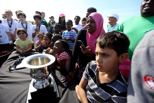 Friends and family watch the trophy presentatation after IRCOM, The Immigrant and Refugee Community Organization of Manitoba Inc. soccer team, defeated St. Johns Ravenscourt during the final game of the boys under 13 city recreation final at John Blumberg, Saturday, September 26, 2015. (TREVOR HAGAN/WINNIPEG FREE PRESS)