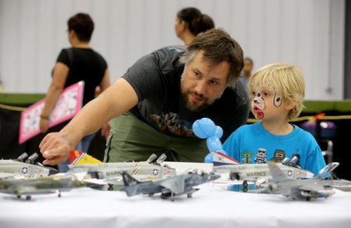 Dan Butcher and his son, Hudson, 4, looking at model planes at the annual Manitoba Mega Train Show at the Red River Ex grounds, Saturday, September 26, 2015. (TREVOR HAGAN/WINNIPEG FREE PRESS)
