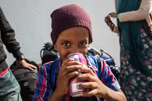 Karin Gordon travels to Emerson, MB to pick up refugees who have made it across the border with the United States. Somali refugee Amin, 6, is all smiles after getting a can of pop Sunday just before leaving Emerson, MB, for Winnipeg. 150927 - Sunday, September 27, 2015 -  MIKE DEAL / WINNIPEG FREE PRESS