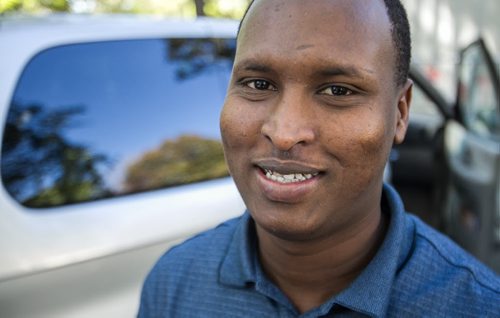 Karin Gordon travels to Emerson, MB to pick up refugees who have made it across the border with the United States. Mahad Mohamed smiles after arriving in Winnipeg from Texas and hopes to be on a bus and in Toronto by Tuesday morning. 150927 - Sunday, September 27, 2015 -  MIKE DEAL / WINNIPEG FREE PRESS