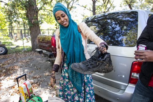 Karin Gordon travels to Emerson, MB to pick up refugees who have made it across the border with the United States. Sahra Ali Ahmed holds up the muddy shoes she had to walk the last few kilometers in because hers got ruined during the crossing of the border overnight. 150927 - Sunday, September 27, 2015 -  MIKE DEAL / WINNIPEG FREE PRESS