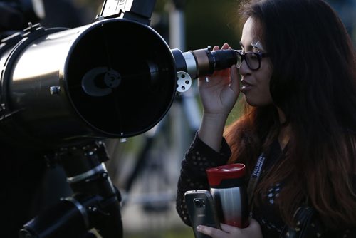 September 27, 2015 - 150927  -  Paula Rufino joined other Winnipeggers who come out to view the eclipse of the moon at Assiniboine Park Sunday, September 27, 2015.  John Woods / Winnipeg Free Press