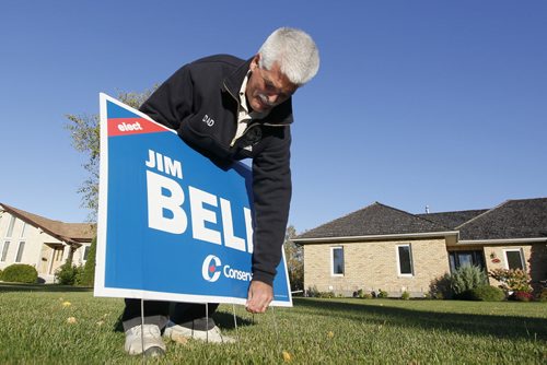 September 28, 2015 - 150928  -  Jim Bell, Conservative candidate for Kildonan-St. Paul campaigns and posts a sign on a supporter's lawn Monday, September 28, 2015.  John Woods / Winnipeg Free Press