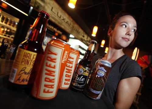 September 28, 2015 - 150928  -  On Monday, September 28, 2015 Luxalune supervisor Amanda Dyck serves up some of the beverages from three local breweries, Farmery, Half Pints and  that have teamed up to buy into the Grey Cup festivities.  John Woods / Winnipeg Free Press