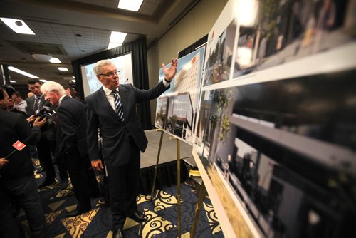 Premier Greg Selinger talks about the new headquarters for Manitoba Liquor and  Lotteries Corp that was unveiled at the RBC Convention Centre Tuesday while Winston Hodgins, president, business development,  Manitoba Liquor and Lotteries talks to reporters in the background.   Sept 29, 2015 Ruth Bonneville / Winnipeg Free Press