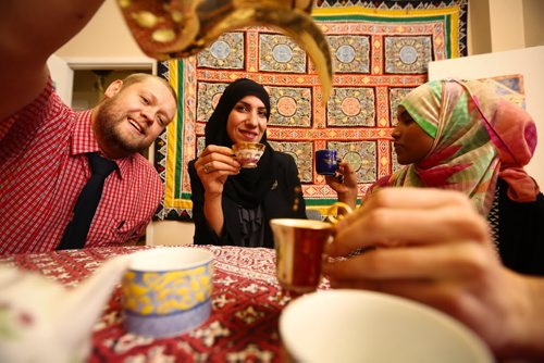 TeaFest coordinator Rubina Atif, centre, has tea with Aaron Goodchild, left, and Muna Maalim at the Islamic Social Services Association in Winnipeg on Tuesday, Sept. 29, 2015.  TeaFest will take place this Sunday at the Franco-Manitoban Cultural Centre, with the goal being to get Canadians chatting over a cup of tea. Mikaela MacKenzie / Winnipeg Free Press