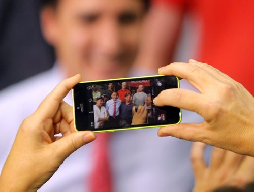 Liberal Party Leader Justin Trudeau at Carte International in Winnipeg on Tuesday. Here he makes time at the end of his speech to do a whack of selfies with people there.  BORIS MINKEVICH / WINNIPEG FREE PRESS  Sept. 29, 2015