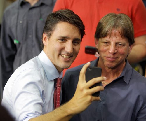 Liberal Party Leader Justin Trudeau at Carte International in Winnipeg on Tuesday. Here he makes time at the end of his speech to do a whack of selfies with people there.  BORIS MINKEVICH / WINNIPEG FREE PRESS  Sept. 29, 2015