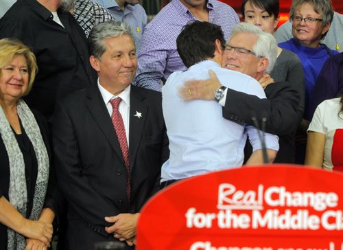 Liberal Party Leader Justin Trudeau at Carte International in Winnipeg on Tuesday.  In photo Liberal candidates MaryAnn Mihychuk, Dan Vandal, and Jim Carr (hugging Trudeau). BORIS MINKEVICH / WINNIPEG FREE PRESS  Sept. 29, 2015