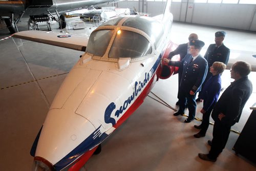 Colonel Andy Cook, Commander of 17 Wing  shows a Snowbird CT-114 Tutor to dignitaries after it was added to the Royal Aviation Museum today on loan from The Royal Canadian Air force  This plane sat on a airforce ramp in the weather for 21 years in Winnipeg-The plane originally was used as a mechanical training plane and is the 4th Tutor from the factory- Standup Photo- Sept 29, 2015   (JOE BRYKSA / WINNIPEG FREE PRESS)