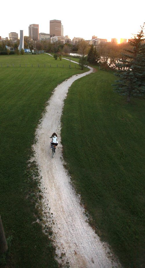 Cyclists and joggers use the trail along the Red River's east shore near Whittier Park across from Waterfront Drive and downtown. September 29, 2015 - (PHIL HOSSACK / WINNIPEG FREE PRESS)