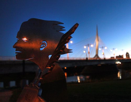 A steel sculpture in tribute to Gabrielle Roy watches over the Provencher Bridge at dusk. September 29, 2015 - (PHIL HOSSACK / WINNIPEG FREE PRESS)