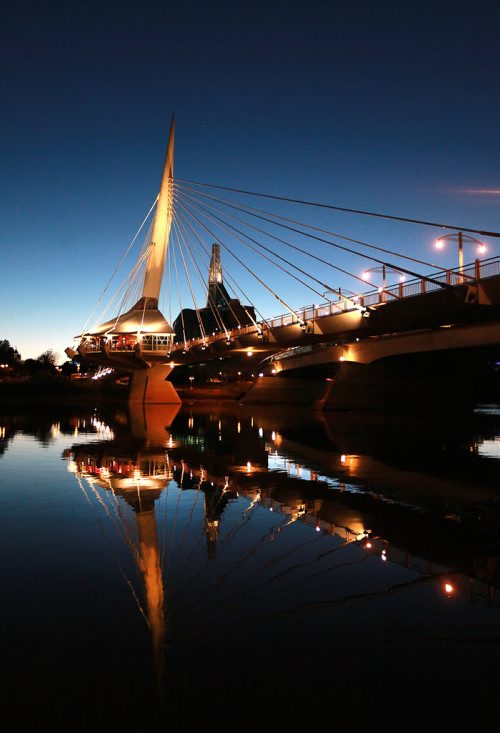 The Esplinade Riel and Provencher Bridge reflect in the Red River at dusk. September 29, 2015 - (PHIL HOSSACK / WINNIPEG FREE PRESS)