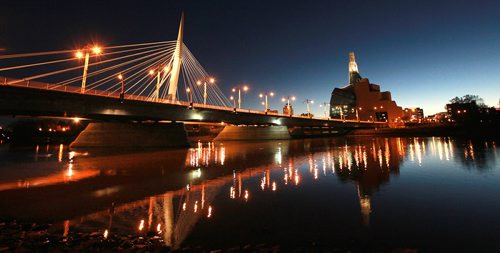 The Esplinade Riel and Provencher Bridge reflect in the Red River beside the Museum for Human Rights at dusk. September 29, 2015 - (PHIL HOSSACK / WINNIPEG FREE PRESS)