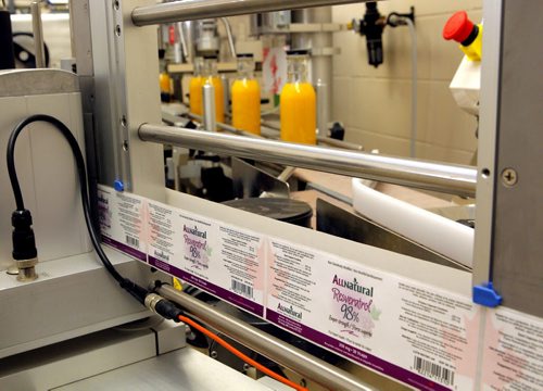 Peter Jones and Tim Hore help put together an upcoming conference in Winnipeg about product packaging. (The Richardson Centre produces and studies foods that can act as medicine). In this photo a sample label that was produced in the centre is diplayed. BORIS MINKEVICH / WINNIPEG FREE PRESS  Sept. 30, 2015