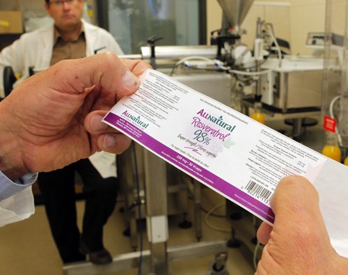 Peter Jones and Tim Hore help put together an upcoming conference in Winnipeg about product packaging. (The Richardson Centre produces and studies foods that can act as medicine). In this photo a sample label that was produced in the centre is diplayed. BORIS MINKEVICH / WINNIPEG FREE PRESS  Sept. 30, 2015