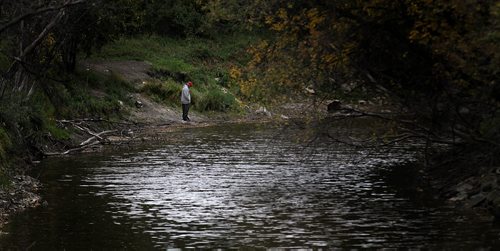 Mike Horbow tends his fishing line on Sturgeon Creek near it's mouth at the Assinaboine River. September 30, 2015 - (PHIL HOSSACK / WINNIPEG FREE PRESS)