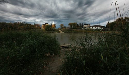 Earth water and sky frame the St Charles Church and Reatreat Center near the west perimeter Hwy where the Assinaboine River enters the city. September 30, 2015 - (PHIL HOSSACK / WINNIPEG FREE PRESS)