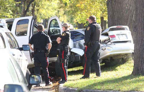 Winnipeg Police investigate inside a truck they were perusing that crashed into a parked car on Lipton St just south of NotreDame Ave Thursday afternoon-It is unknown if arrests were made or if there were injuries- Canine unit arrived at scene- Breaking News- Sept 30, 2015   (JOE BRYKSA / WINNIPEG FREE PRESS)