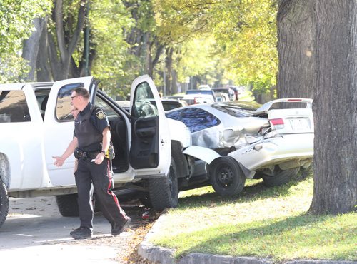 Winnipeg Police investigate inside a truck they were perusing that crashed into a parked car on Lipton St just south of NotreDame Ave Thursday afternoon-It is unknown if arrests were made or if there were injuries- Canine unit arrived at scene- Breaking News- Sept 30, 2015   (JOE BRYKSA / WINNIPEG FREE PRESS)