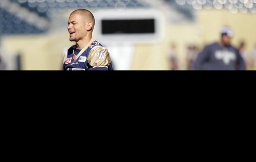 Winnipeg Blue Bomber Nick Moore deepens his relationship with the pigskin during the team's walk through practice Friday morning. See story. October 2, 2015 - (PHIL HOSSACK / WINNIPEG FREE PRESS)